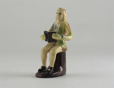 Appraisal: An Astbury Whieldon type creamware figure of a musician seated