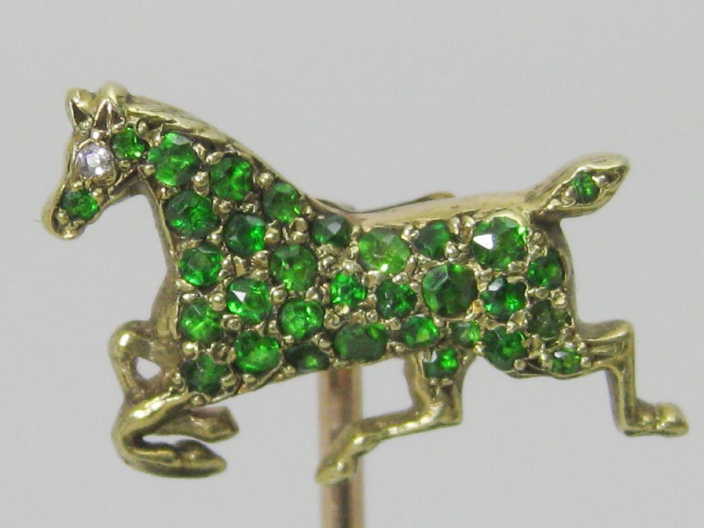 Appraisal: A gold Stick Pin with galloping horse finial set emeralds