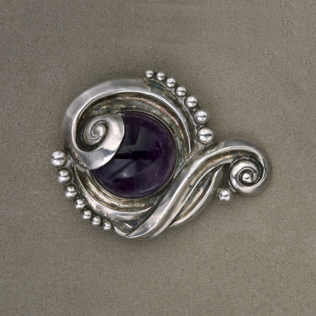 Appraisal: MEXICAN SILVER BROOCH SET WITH A CABOUCHON AMETHYST Of circular