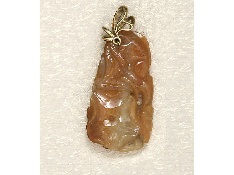 Appraisal: CARVED JADE PENDANT Carved jadeite with cinnamon and light green