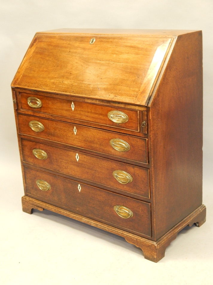 Appraisal: A George III mahogany bureau the fall enclosing a fitted