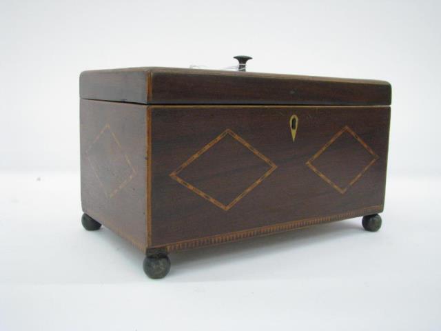 Appraisal: An antique English mahogany tea caddy with marquetry inlay divided