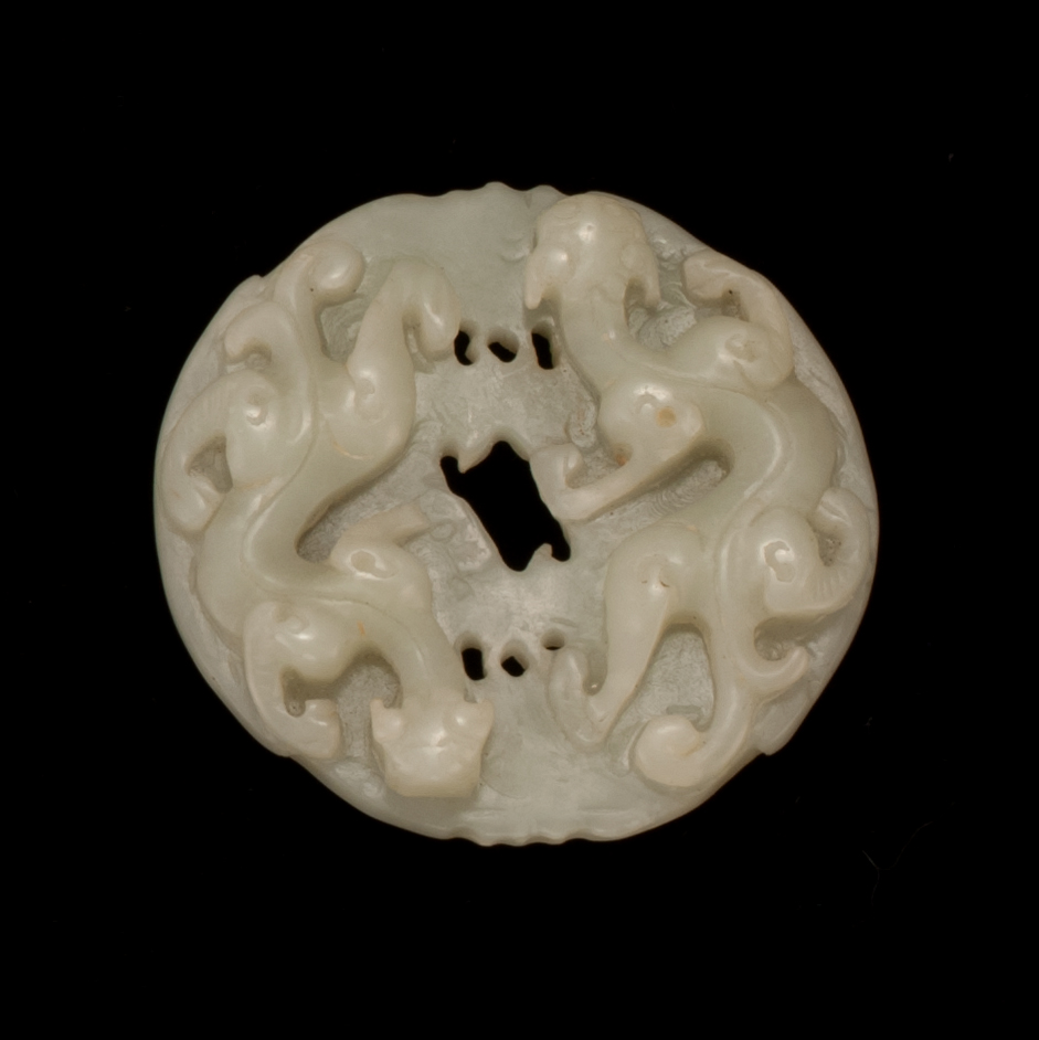 Appraisal: CELADON JADE PENDANT In circular form With relief qilong dragon