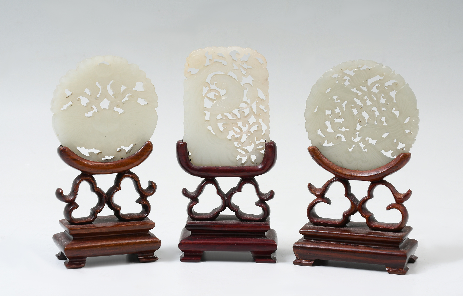 Appraisal: PC CARVED CHINESE JADE PENDANTS ON STANDS Comprising - Celadon