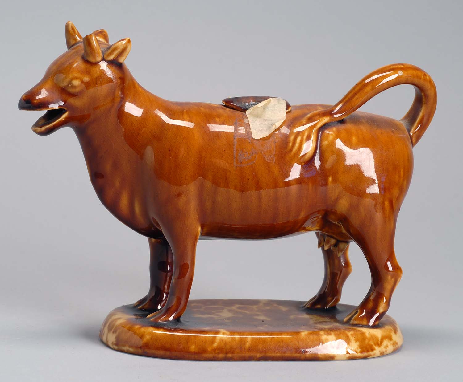 Appraisal: TH CENTURY ROCKINGHAM POTTERY COW CREAMER Height Length ConditionOne horn