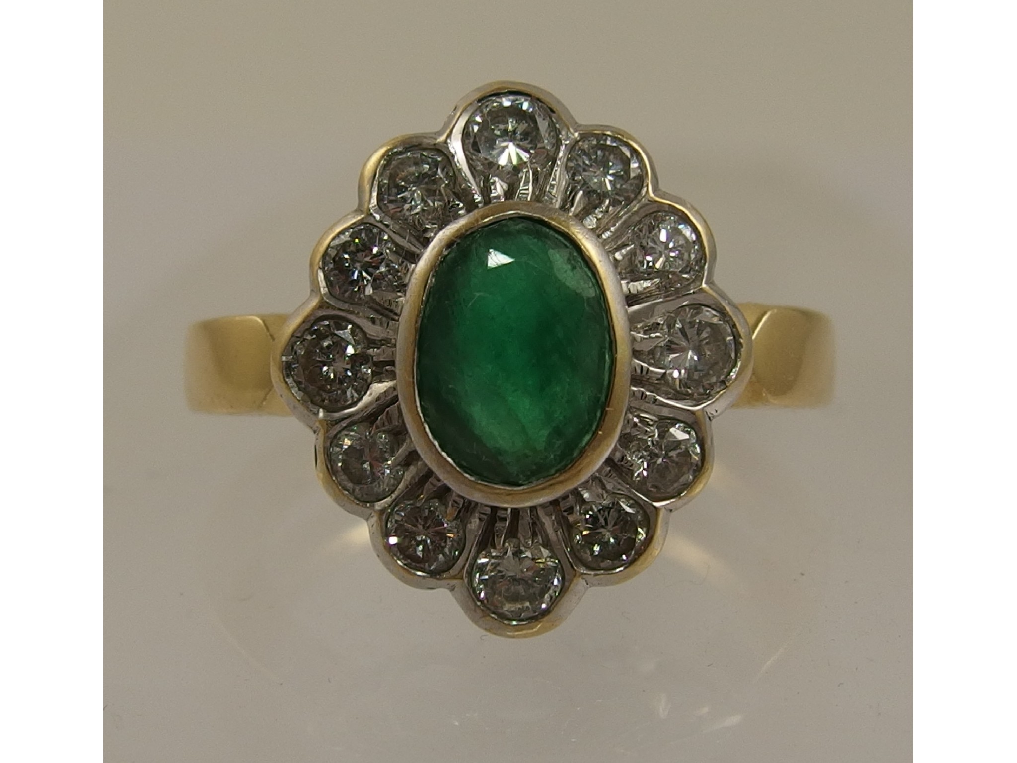 Appraisal: An ct emerald and diamond ringthe central oval cut emerald