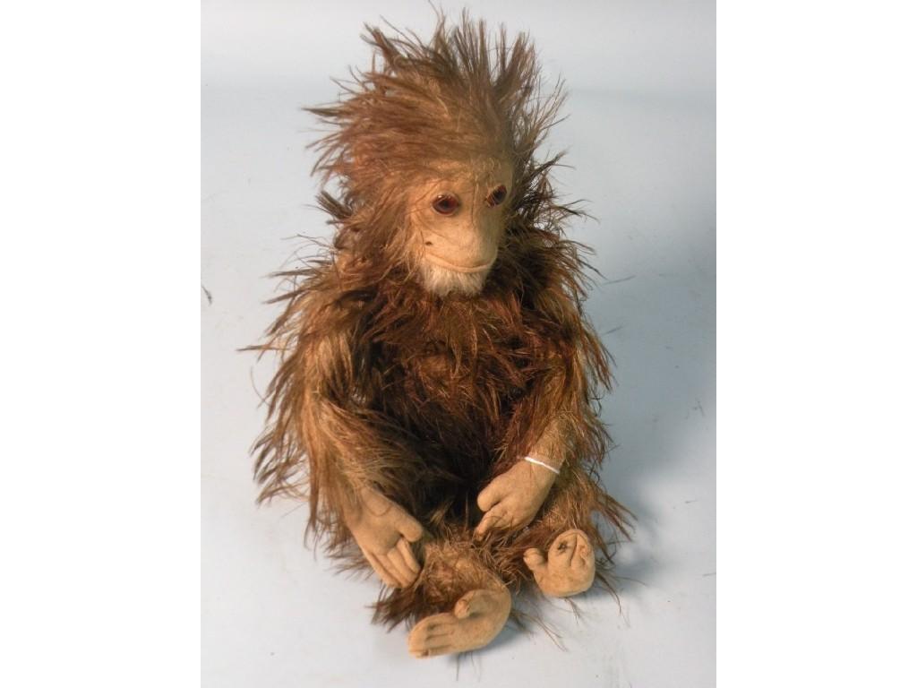 Appraisal: A toy mohair monkey with glass eyes straw filling and