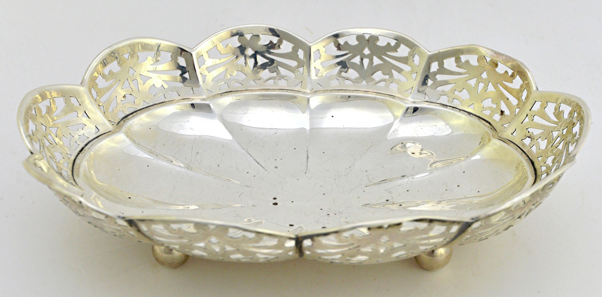 Appraisal: A silver shaped oval shallow bowl decorated with a pierced