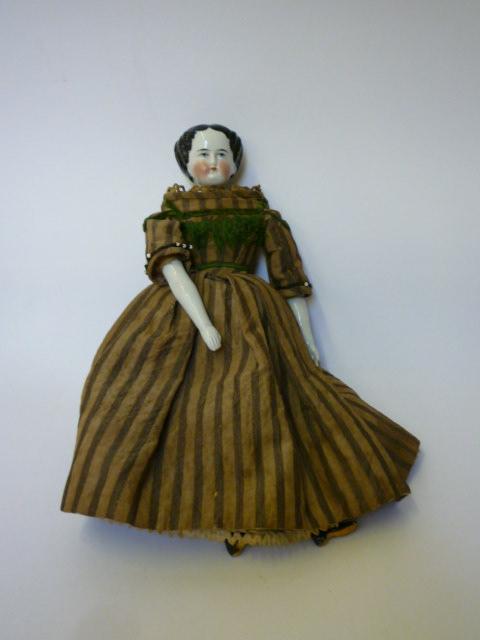 Appraisal: A late Victorian china shoulder head girl doll with painted