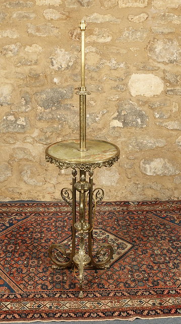 Appraisal: A BRASS AND ONYX STANDARD LAMP with acanthus scroll supports