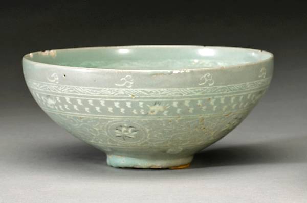 Appraisal: A celadon glazed stoneware bowl with sanggam decoration Goryeo Dynasty