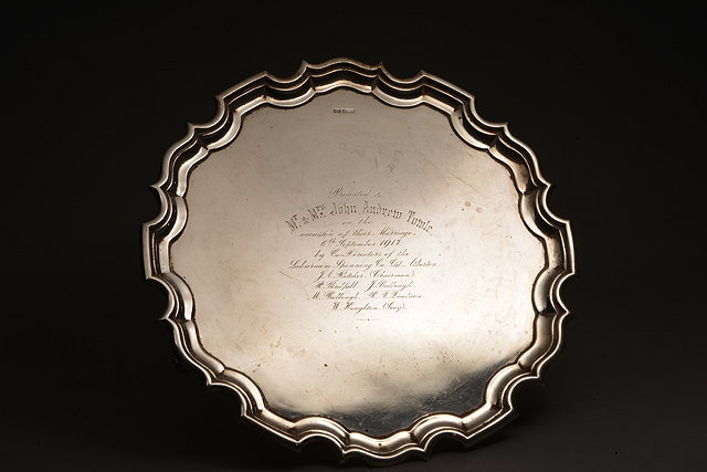 Appraisal: A CHIPPENDALE STYLE SILVER PRESENTATION SALVER with piecrust edge and