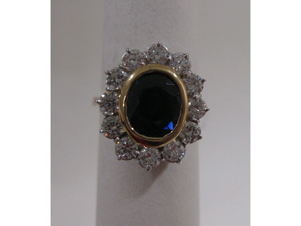 Appraisal: Eighteen carat gold sapphire and diamond cluster ring with central