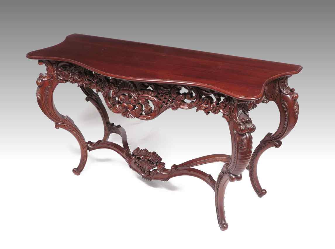 Appraisal: CARVED INDONESIAN MAHOGANY CONSOLE TABLE Shaped top with profusely carved