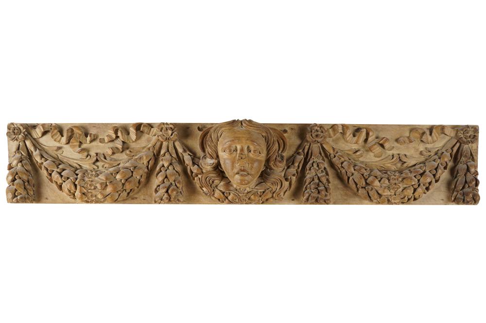 Appraisal: CONTINENTAL RELIEF-CARVED WOOD PANELthe central mask flanked by ribbon-tied garlands