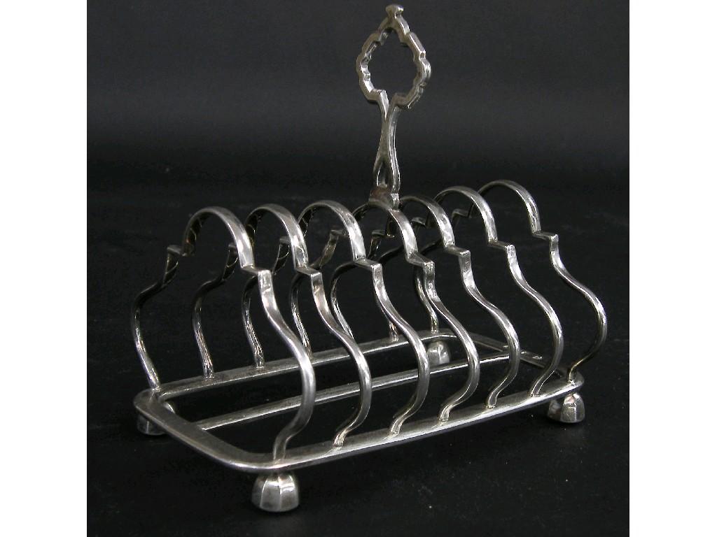 Appraisal: Victorian serpentine toast rack with pierced handle and upon bun