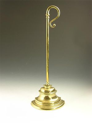 Appraisal: A late Victorian brass door stop with a weighted base