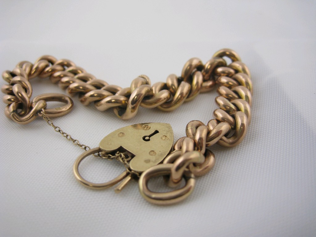 Appraisal: A ct gold curb link Bracelet with padlock fastener approx