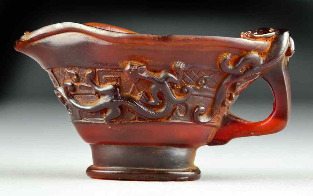 Appraisal: Chinese Carved Horn Libation CupFinely carved depicting four chilong circling