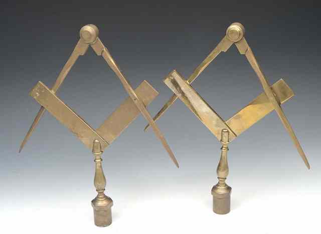 Appraisal: A PAIR OF BRASS MASONIC BANNER HEADS in the form