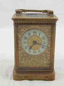 Appraisal: A brass carriage clock with enamel chapter ring on decorated