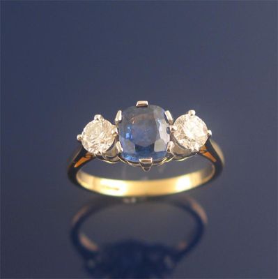 Appraisal: A sapphire and diamond three stone ring the oval shaped