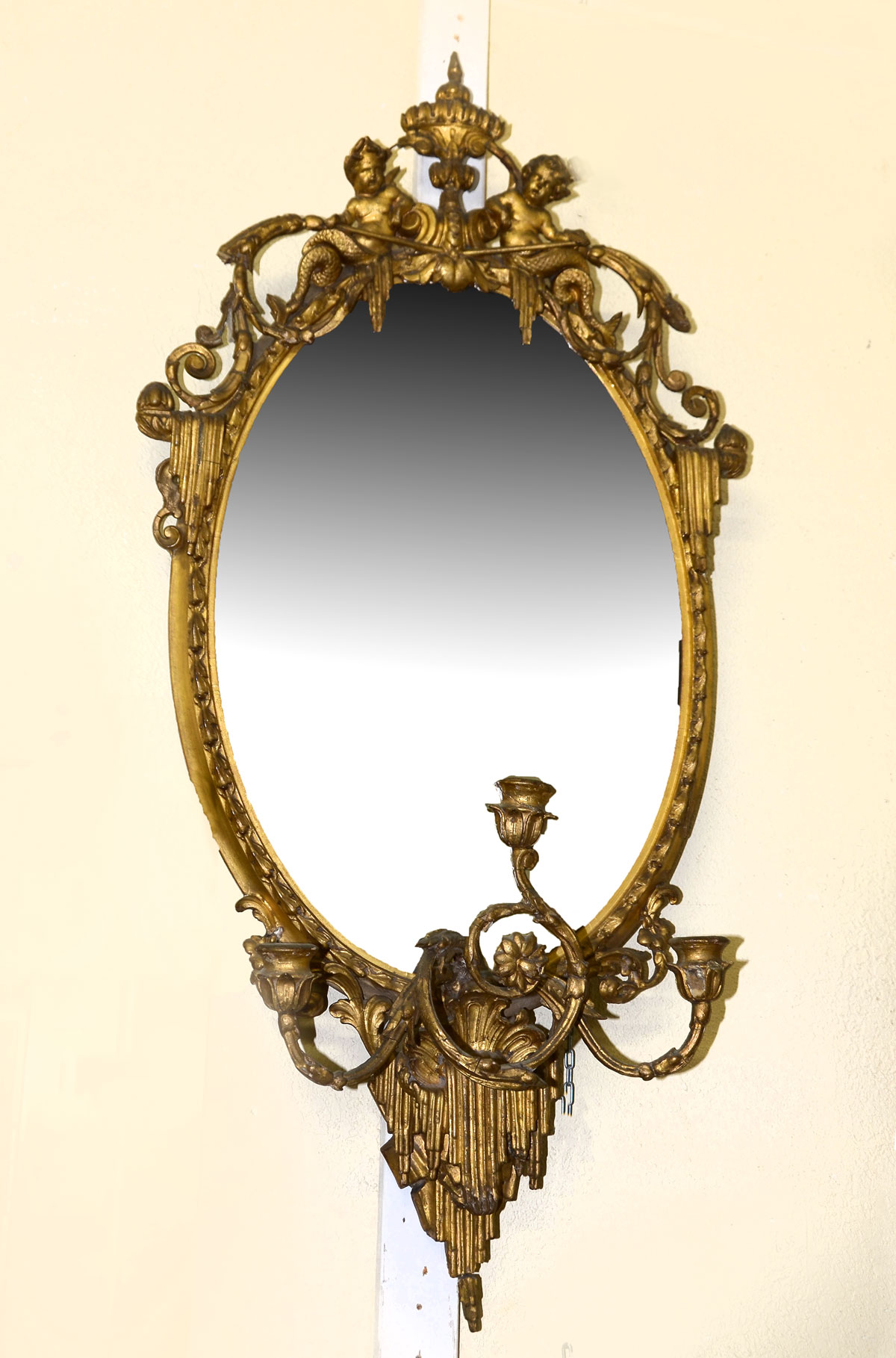 Appraisal: CARVED WALL MIRROR WITH CHERUBIC CREST Wall mirror having an