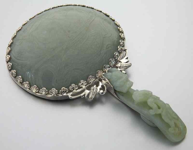 Appraisal: Chinese Qing carved jade hand mirror the belt buckle handle