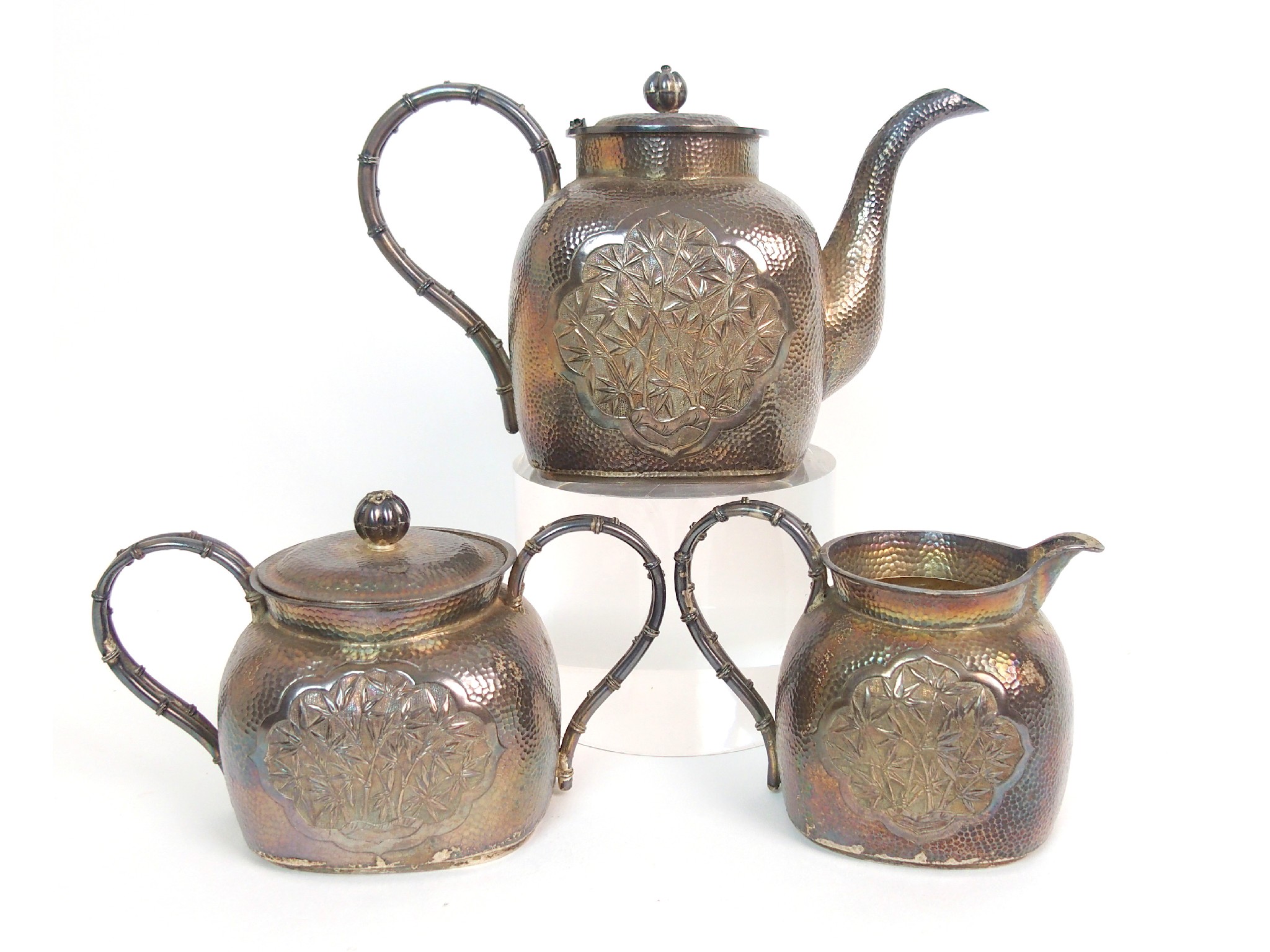 Appraisal: A Chinese silver three piece tea servicecast with ogival panels