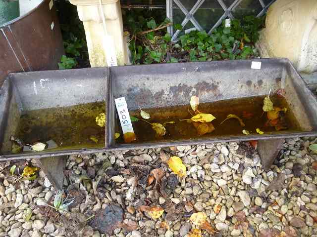 Appraisal: A VICTORIAN HEAVY IRON TWO DIVISIONAL FEEDING TROUGH on shaped