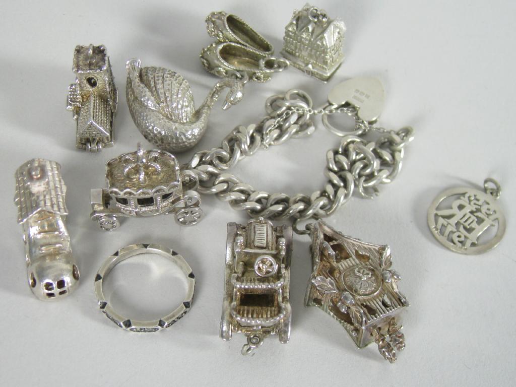 Appraisal: A silver curb-link Bracelet and nine silver Charms including slippers