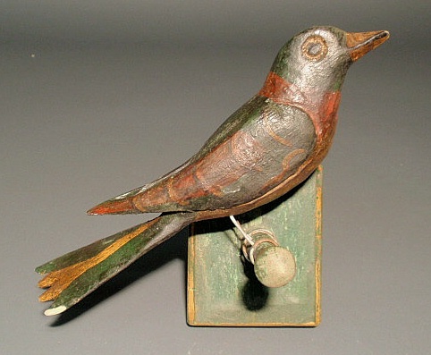 Appraisal: German folk art carved bird with paint decoration and green