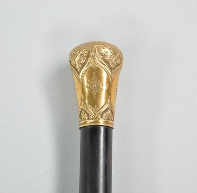 Appraisal: A Walking Stick with A Decorative Knob An ebony cane