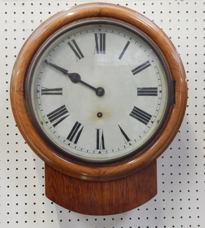 Appraisal: A Victorian oak circular cased wall clock by Camerer Kuss