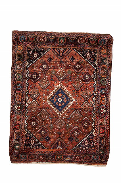 Appraisal: A PERSIAN AFSHAR RUST GROUND RUG decorated a central stylised