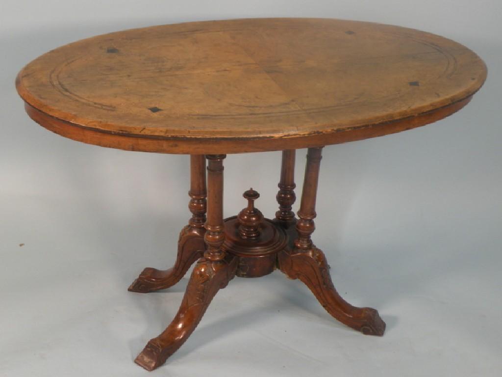 Appraisal: A Victorian walnut occasional table on turned supports with cabriole