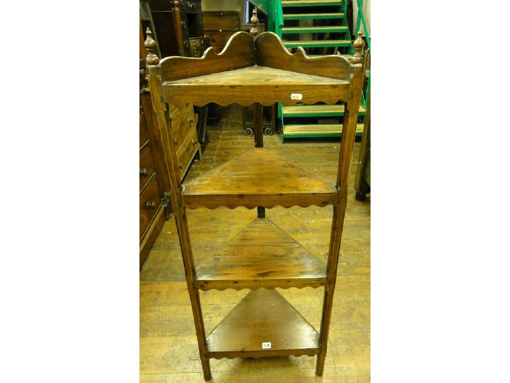 Appraisal: A four tier freestanding corner what not raised on square