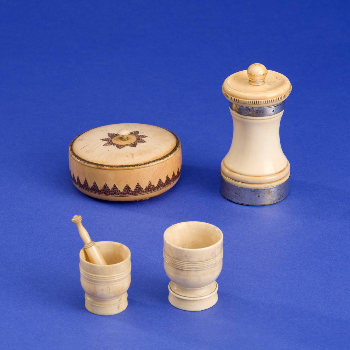 Appraisal: FOUR CARVED WHALEBONE ARTICLES INCLUDING A SILVER BANDED PEPPER MILL