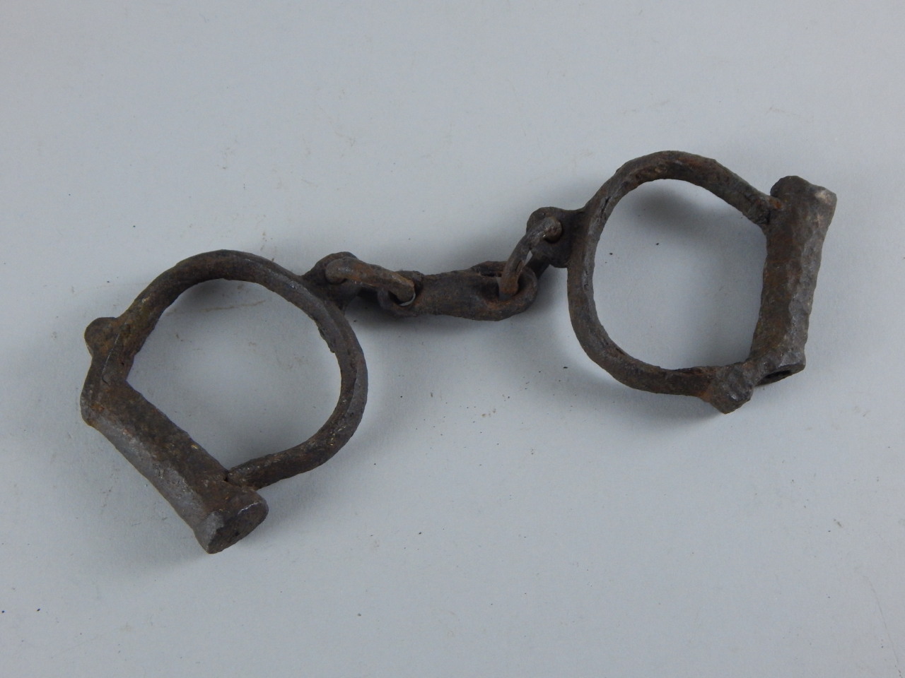 Appraisal: A pair of iron child's hand cuffs two link centres