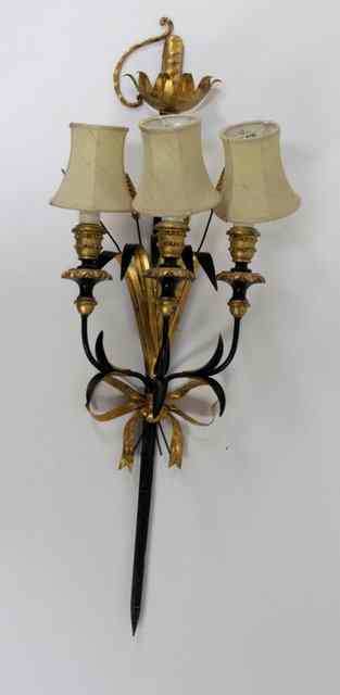 Appraisal: An ebonised metal and gilt wood three branch wall light