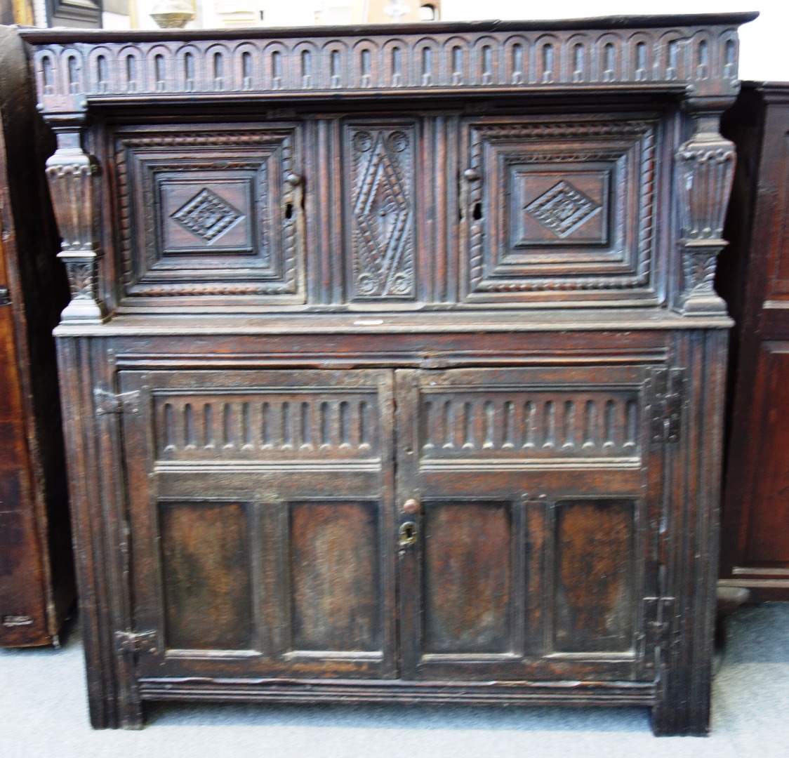 Appraisal: A th century oak court cupboard with pair of carved