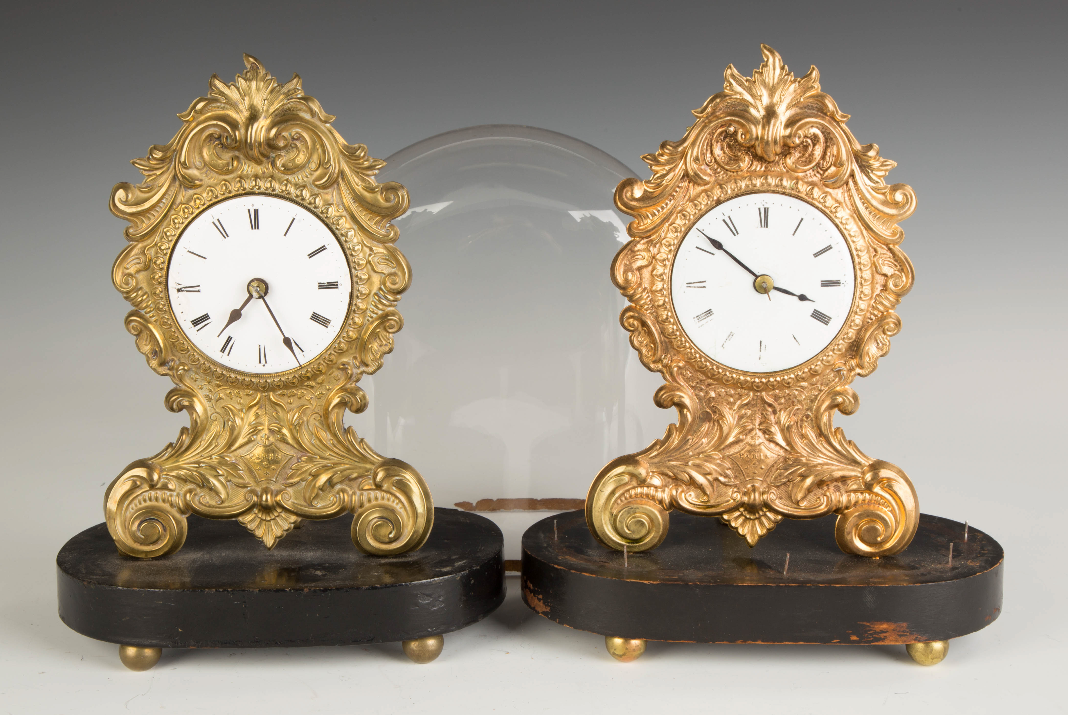 Appraisal: Two Stamped Brass Clocks Porcelain dials Balance wheel movements