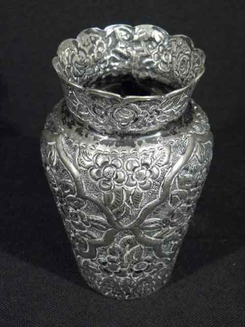 Appraisal: A small middle eastern silver vase Floral embossed pattern marked