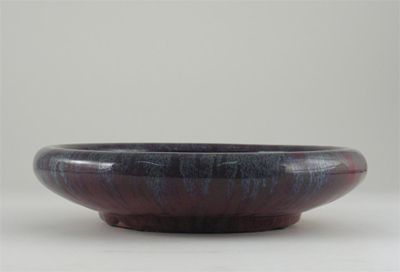 Appraisal: A Chinese flamb glazed shallow bowl the unctuous glaze flecked