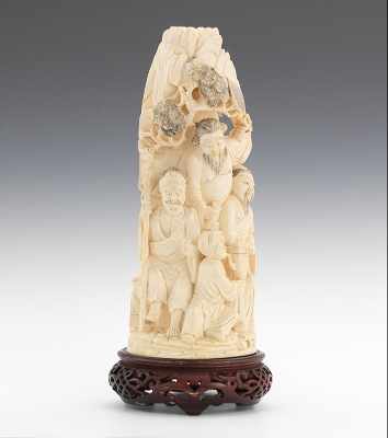 Appraisal: A Carved Ivory Figural Carved depicting a cluster of figures