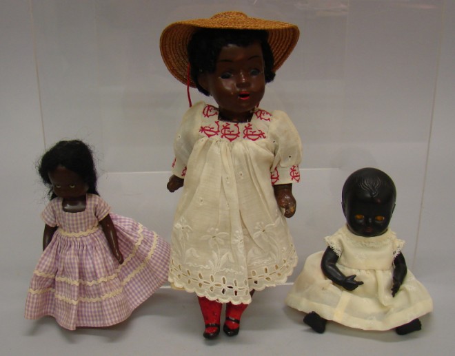 Appraisal: Lot of black dolls Unmarked papier mache doll with stationary