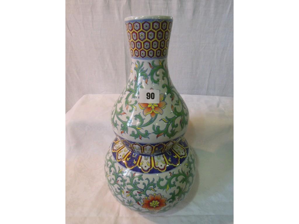 Appraisal: An oriental double gourd shaped vase with polychrome painted trailing