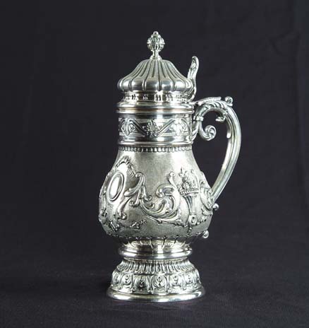 Appraisal: CONTINENTAL SILVER COVERED TANKARD th century Pear-shaped body with stippled