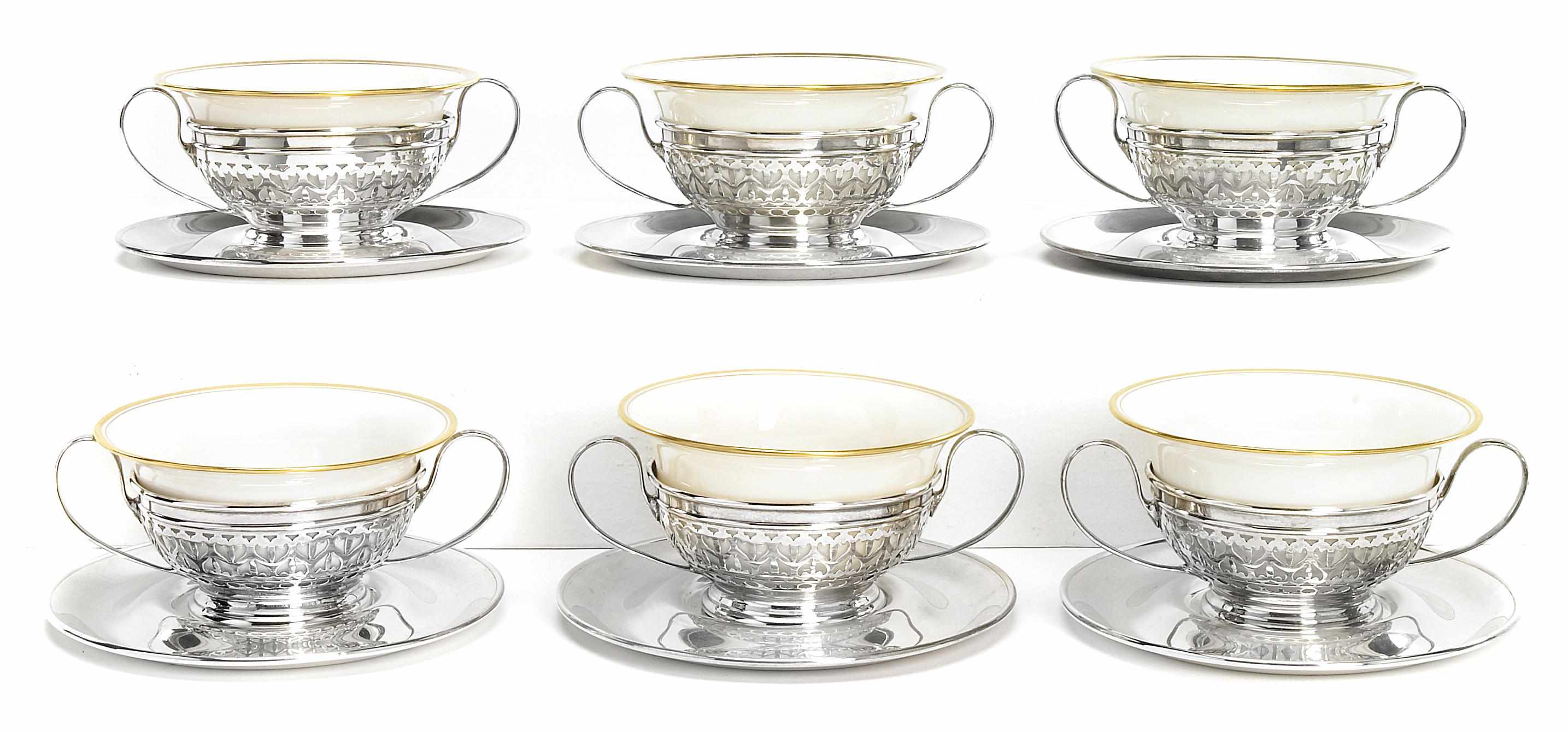 Appraisal: A sterling set of fourteen bouillon cup frames and porcelain