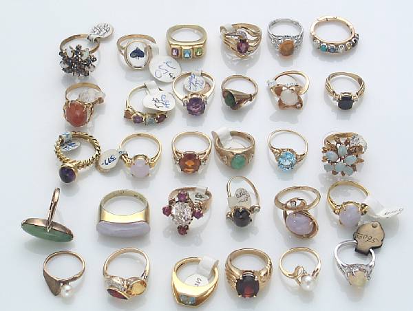 Appraisal: A collection of thirty gem-set gold rings and metal rings